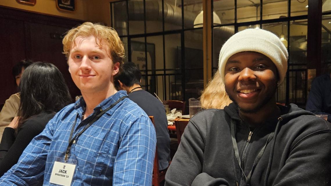 Image of two alumni seated at restaurant table