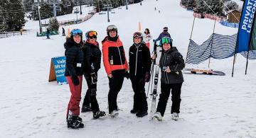 Parent skiers and snowboarders greeted by snowy runs