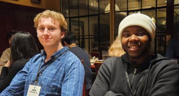 Image of two alumni seated at restaurant table